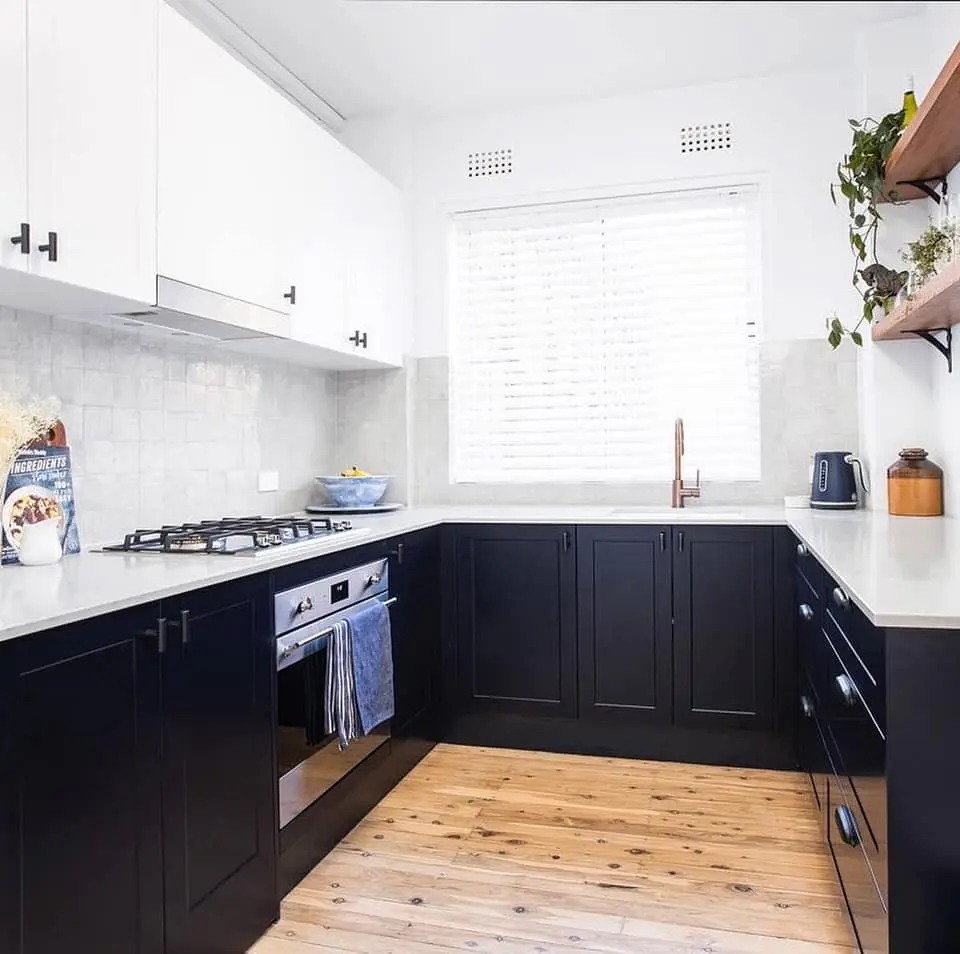 Black and white apartment kitchen renovation with timber flooring in Bondi