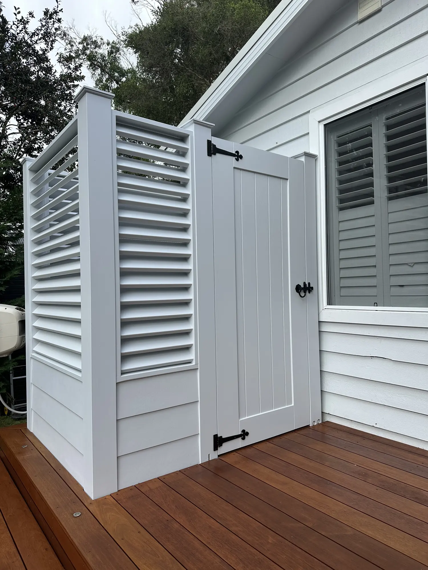 Closed timber door and louvred privacy screen at the Erina Heights shower