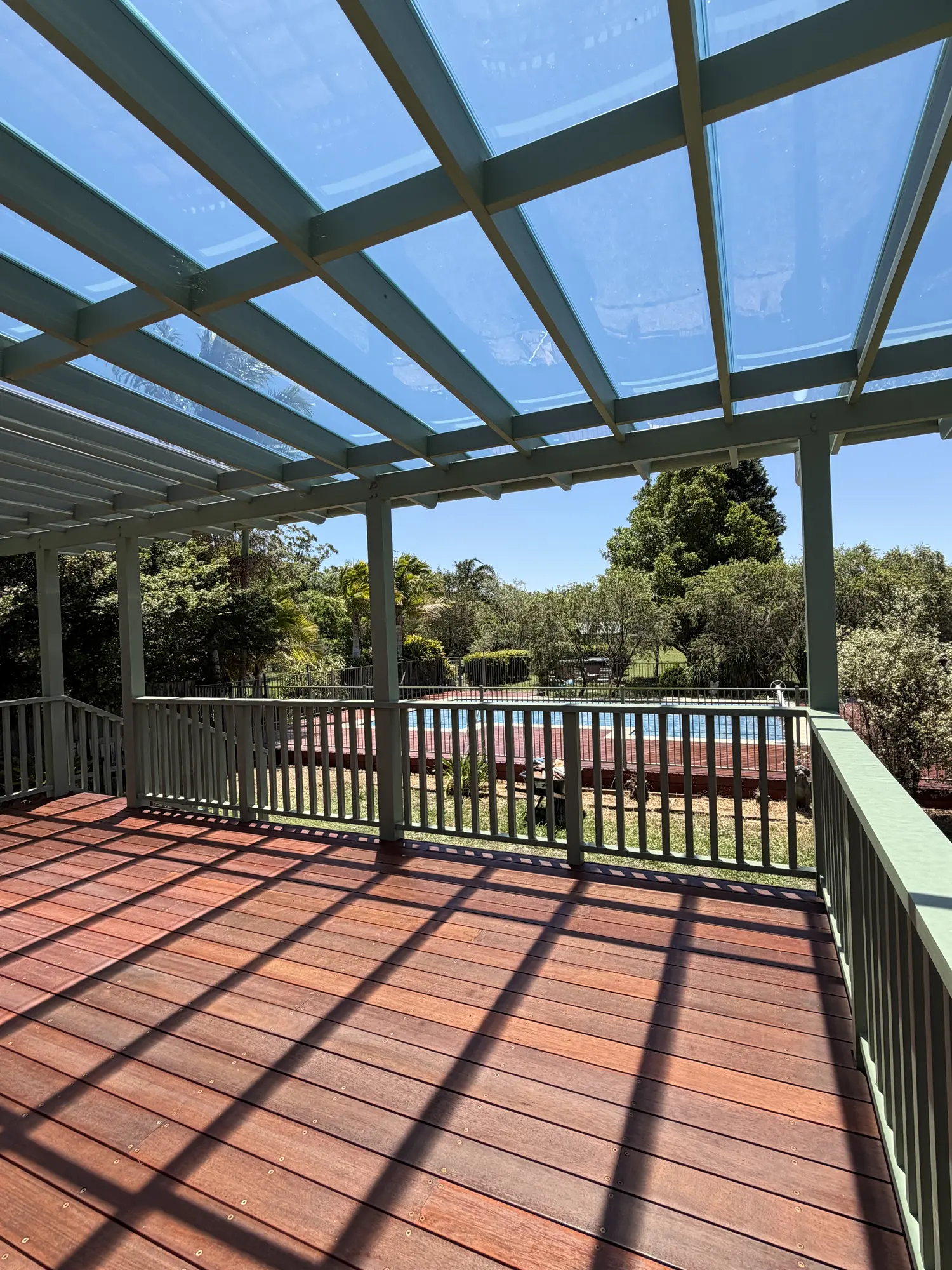 Merbau deck and detailed H3 pine pergola with clear roof panels in Lisarow