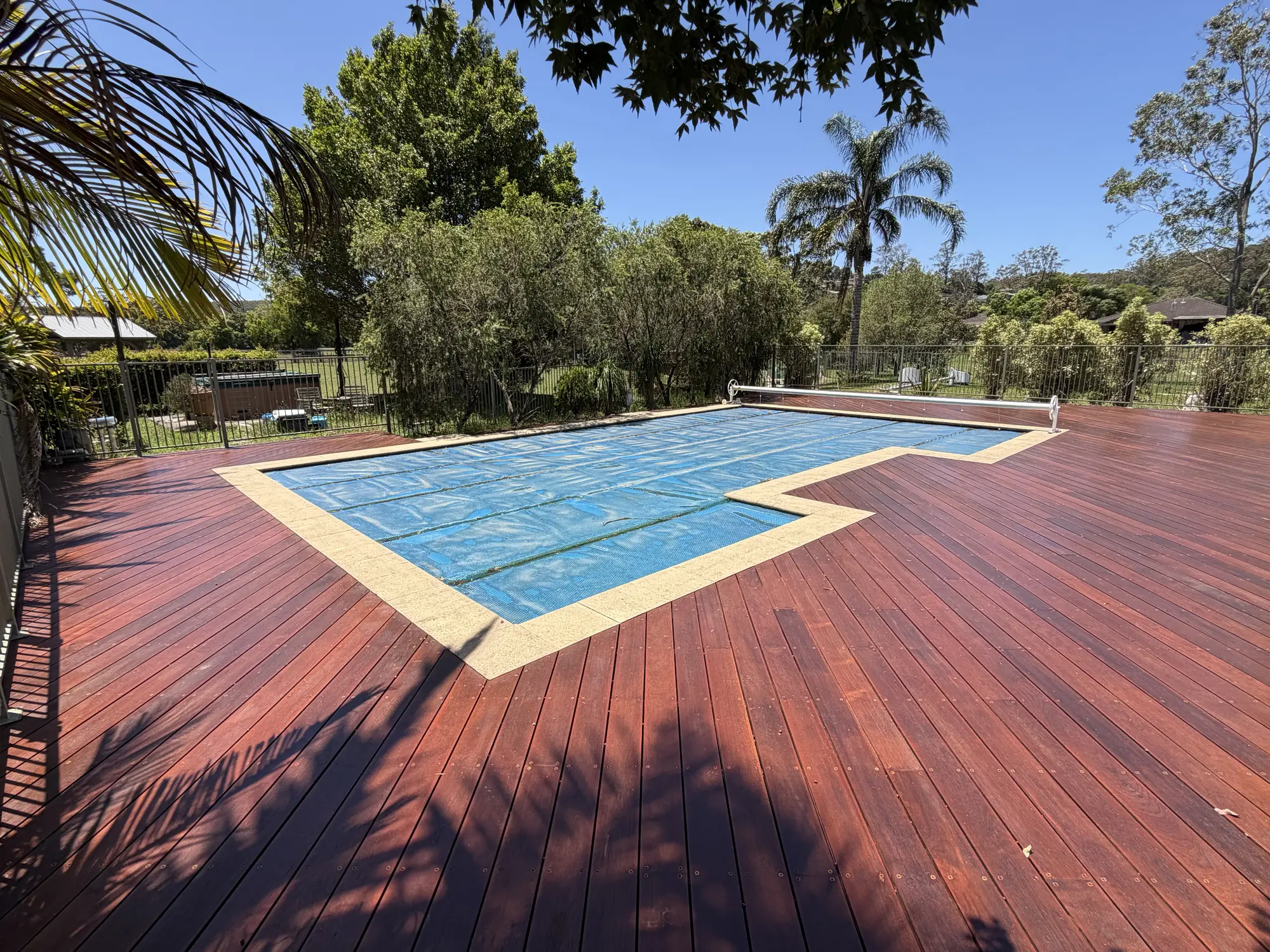 Wide Merbau pool deck completed around a Lisarow swimming pool