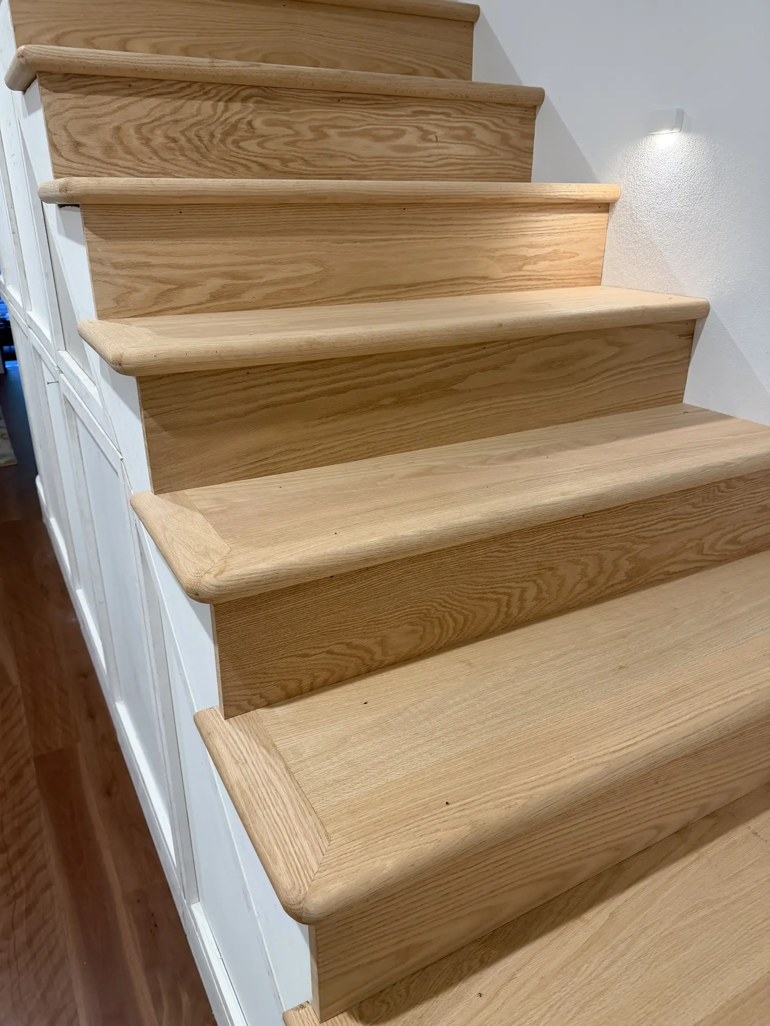American Oak treads fitted over the turning stair geometry in Surry Hills