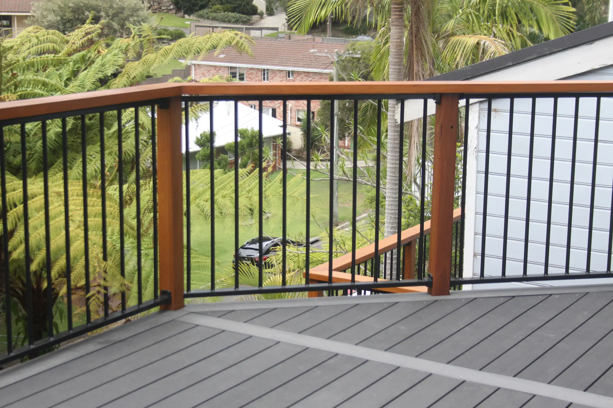 Terrigal Ekodeck composite boards meeting a custom Blackbutt post and balustrade