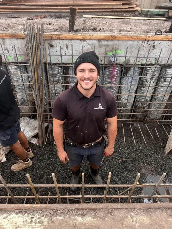 Licensed builder Zach reviewing dimensions and reinforcement on an active structural residential site